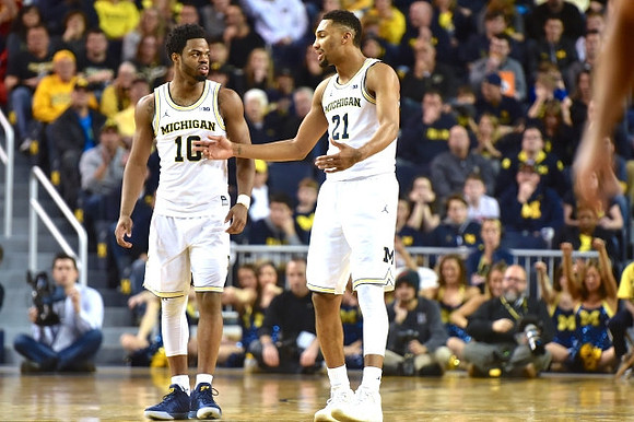 Derrick Walton Jr. (10) and Zak Irvin (21)