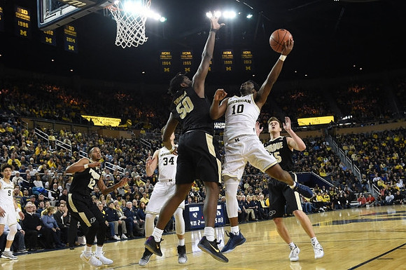 D.J. Wilson (5), Mark Donnal (34), and Derrick Walton Jr. (10)