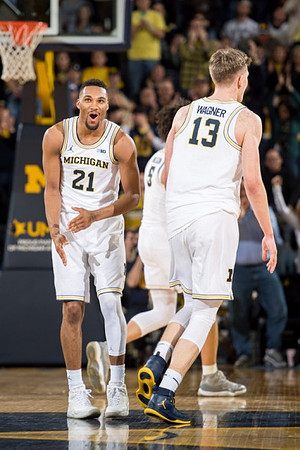 Zak Irvin (21), D.J. Wilson (5), and Moritz Wagner (13)