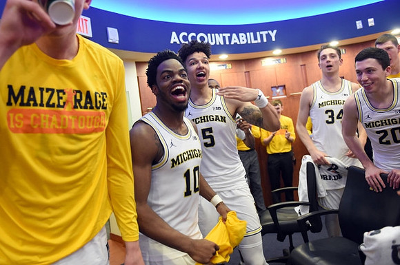 Derrick Walton Jr. (10), D.J. Wilson (5), Mark Donnal (34), and Sean Lonergan (20)