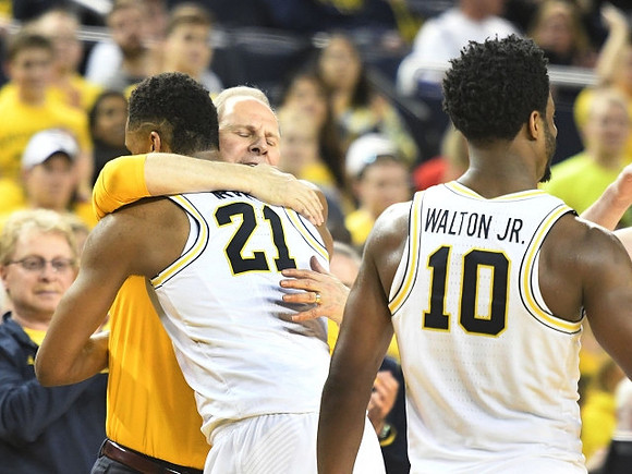 John Beilein, Zak Irvin (21), and Derrick Walton Jr. (10)