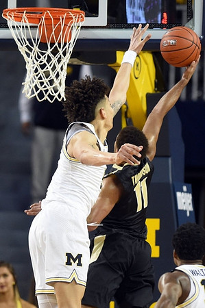 D.J. Wilson (5) and Derrick Walton Jr. (10)