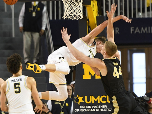D.J. Wilson (5) and Moritz Wagner (13)