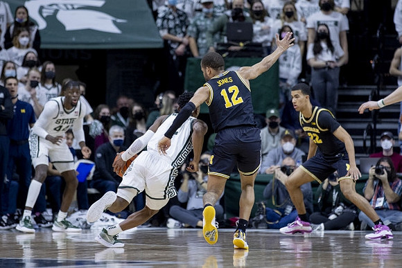 DeVante' Jones (12) and Caleb Houstan (22)