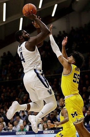 Eli Brooks (55) and Zavier Simpson (3)