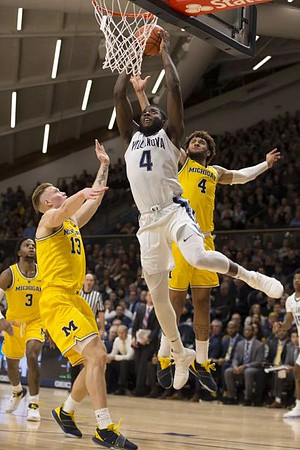 Zavier Simpson (3), Ignas Brazdeikis (13), and Isaiah Livers (4)