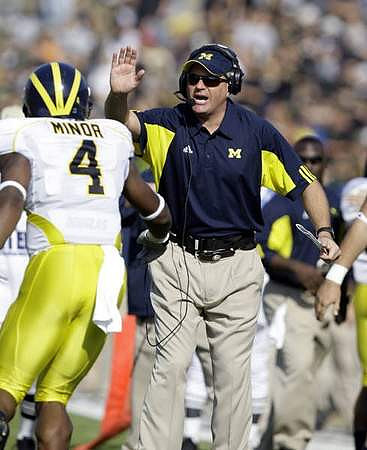 Brandon Minor (4) and Rich Rodriguez