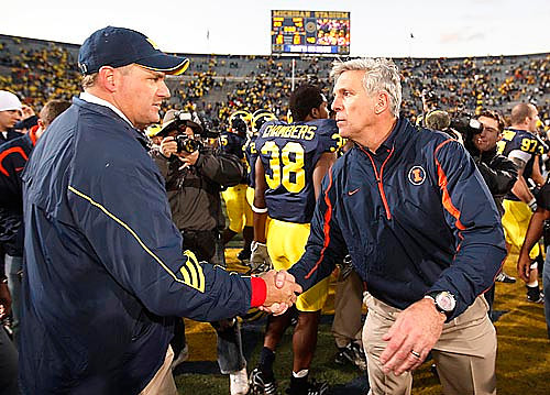 Rich Rodriguez, Ron Zook, Artis Chambers (38), and Will Johnson (97)