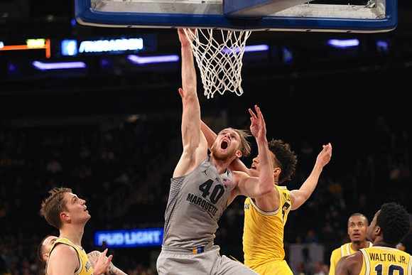 Mark Donnal (34), D.J. Wilson (5), Muhammad-Ali Abdur-Rahkman (12), and Derrick Walton Jr. (10)