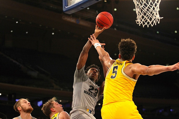 Mark Donnal (34) and D.J. Wilson (5)