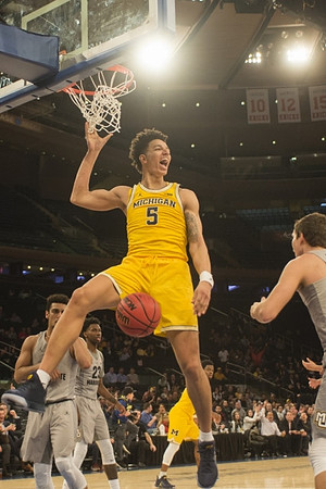 D.J. Wilson (5) and Derrick Walton Jr. (10)