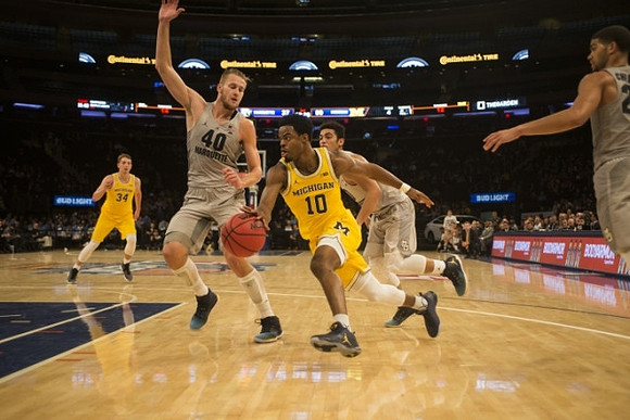 Mark Donnal (34) and Derrick Walton Jr. (10)