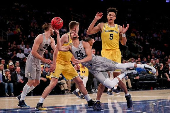 Moritz Wagner (13) and D.J. Wilson (5)