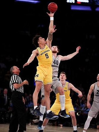D.J. Wilson (5) and Moritz Wagner (13)