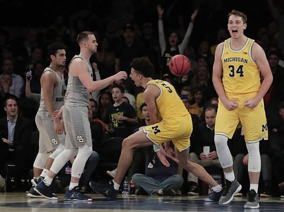 D.J. Wilson (5) and Mark Donnal (34)