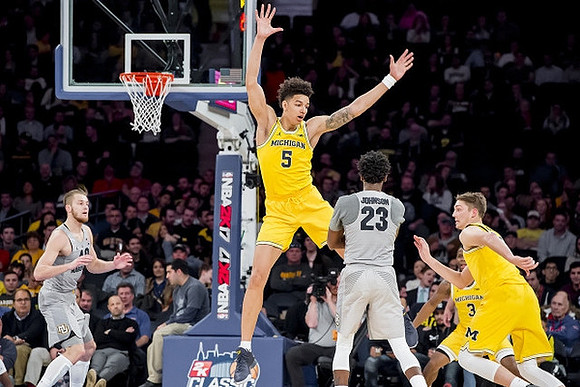 D.J. Wilson (5), Xavier Simpson (3), and Mark Donnal (34)