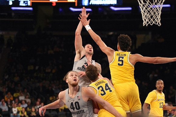 Mark Donnal (34), D.J. Wilson (5), and Muhammad-Ali Abdur-Rahkman (12)