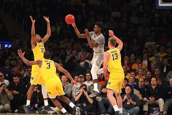 Zak Irvin (21), Xavier Simpson (3), and Moritz Wagner (13)