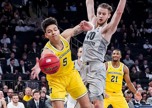 D.J. Wilson (5) and Zak Irvin (21)