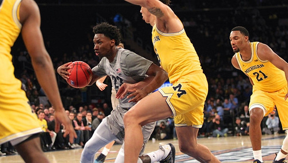 D.J. Wilson (5) and Zak Irvin (21)