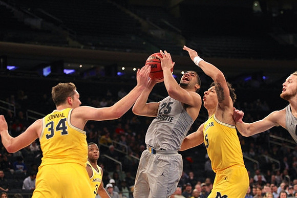 Mark Donnal (34) and D.J. Wilson (5)