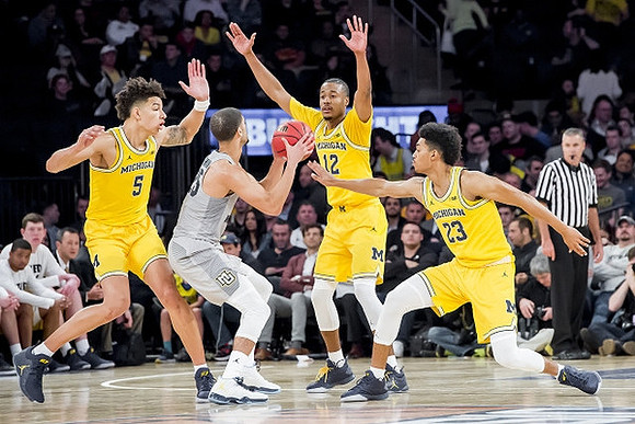 D.J. Wilson (5), Muhammad-Ali Abdur-Rahkman (12), and Ibi Watson (23)