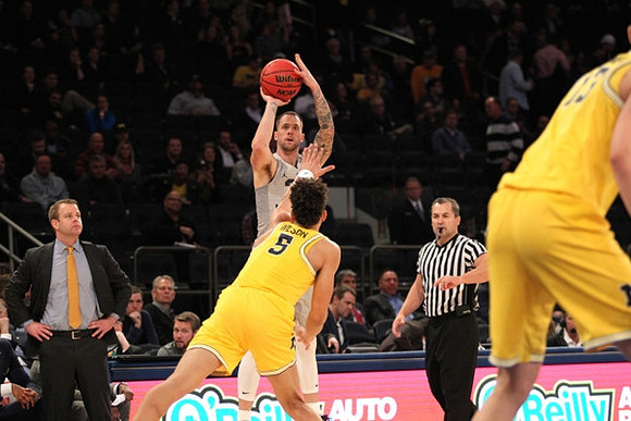 Marquette Head Coach Steve Wojciechowski , D.J. Wilson (5), and Moritz Wagner (13)
