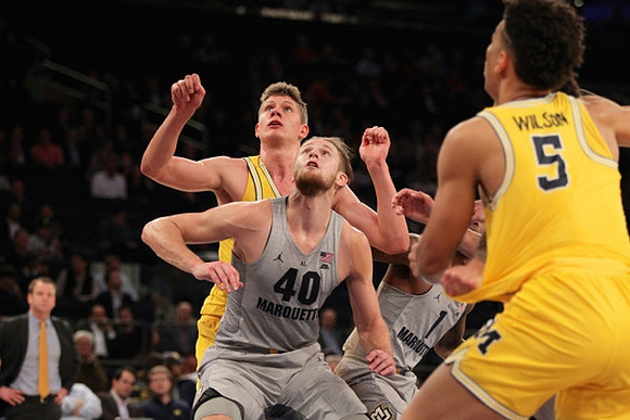 Moritz Wagner (13) and D.J. Wilson (5)