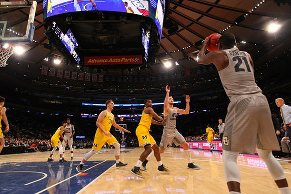 D.J. Wilson (5), Ibi Watson (23), Mark Donnal (34), Xavier Simpson (3), and Muhammad-Ali Abdur-Rahkman (12)