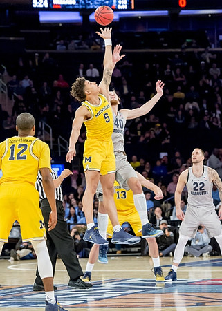 Muhammad-Ali Abdur-Rahkman (12), D.J. Wilson (5), and Moritz Wagner (13)