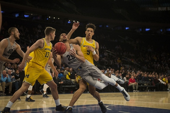 Moritz Wagner (13) and D.J. Wilson (5)