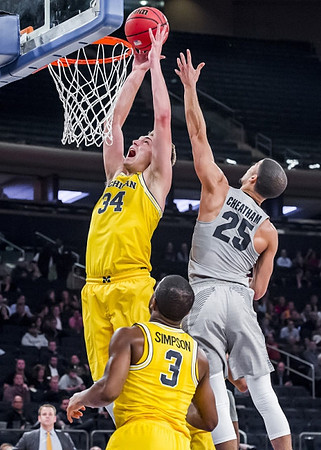Mark Donnal (34) and Xavier Simpson (3)