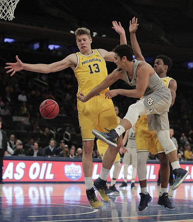 Moritz Wagner (13) and Derrick Walton Jr. (10)