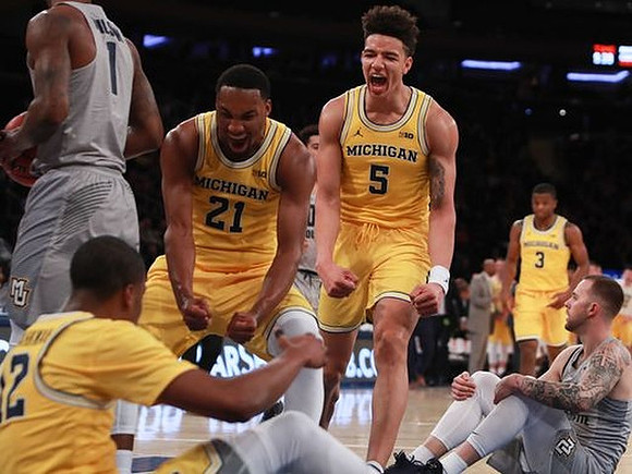 Zak Irvin (21), Zak Irvin (21), D.J. Wilson (5), and Xavier Simpson (3)