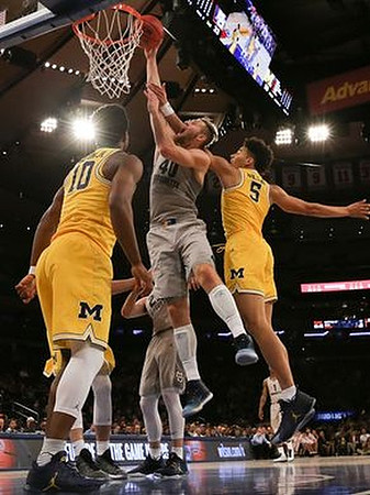 Derrick Walton Jr. (10) and D.J. Wilson (5)