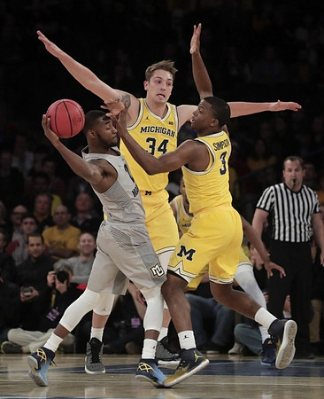 Mark Donnal (34) and Xavier Simpson (3)