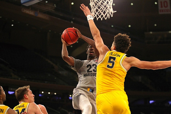 Mark Donnal (34) and D.J. Wilson (5)