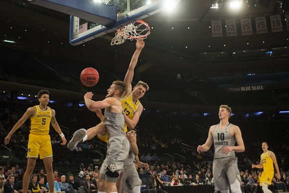 D.J. Wilson (5), Moritz Wagner (13), and Duncan Robinson (22)