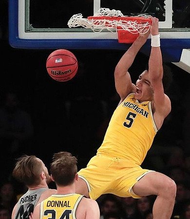 D.J. Wilson (5) and Mark Donnal (34)