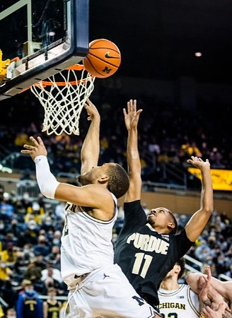 DeVante' Jones (12) and Brandon Johns Jr. (23)