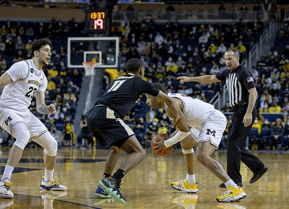 Brandon Johns Jr. (23) and DeVante' Jones (12)