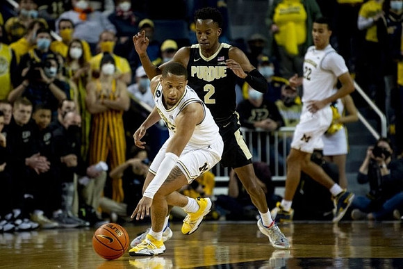 DeVante' Jones (12) and Caleb Houstan (22)