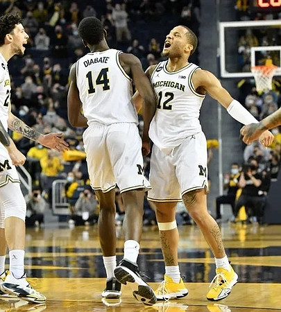 Brandon Johns Jr. (23), Moussa Diabate (14), and DeVante' Jones (12)