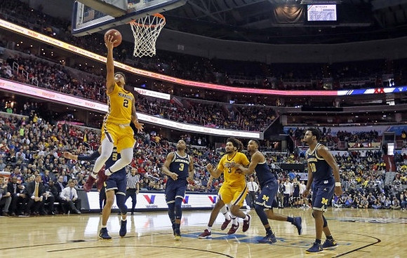 D.J. Wilson (5), Xavier Simpson (3), Zak Irvin (21), and Derrick Walton Jr. (10)