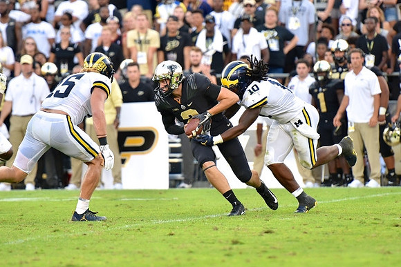 Chase Winovich (15) and Devin Bush (10)