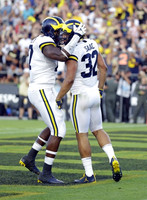 Tyrone Wheatley Jr. (17) and Ty Isaac (32)