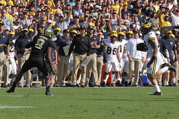 Henry Poggi (19) and Jim Harbaugh