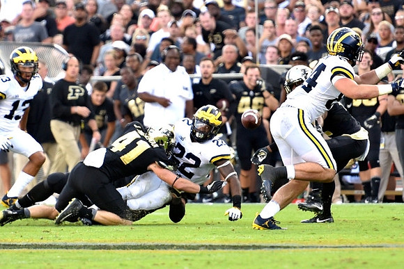 Eddie McDoom (13), Karan Higdon (22), and Sean McKeon (84)