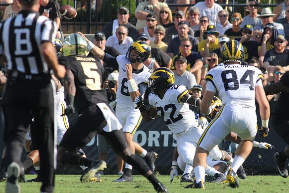John O'Korn (8), Karan Higdon (22), and Sean McKeon (84)