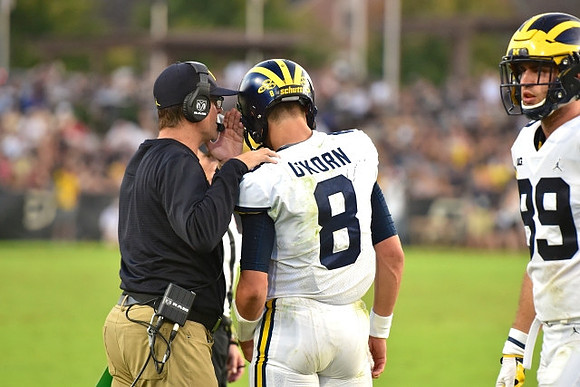 Jim Harbaugh, John O'Korn (8), and Ian Bunting (89)